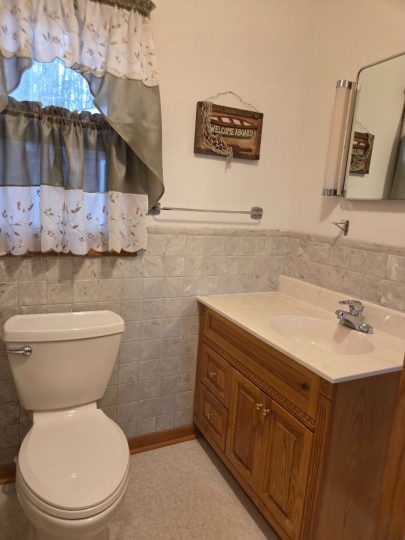 Cozy bathroom with nautical decor and wooden vanity