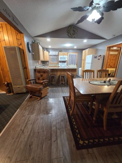 Cozy cabin interior with dining area and open kitchen