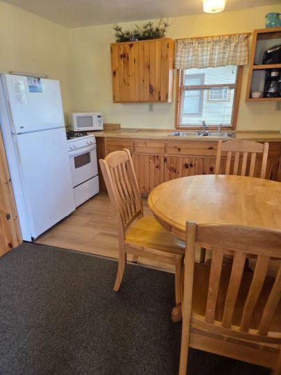 Cozy cabin kitchen with wooden cabinets and dining table