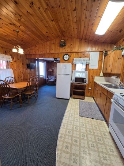 Cozy rustic cabin interior with kitchen and dining area