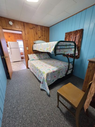Cozy cabin bedroom with bunk beds and beach-themed bedding