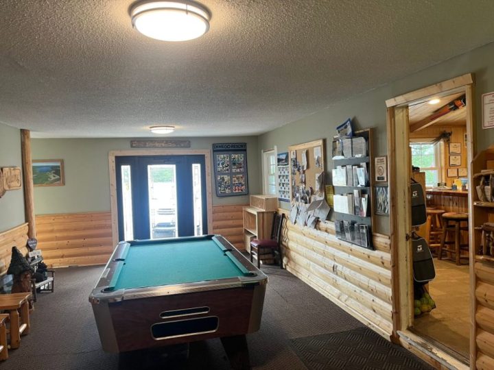 Pool table in a rustic resort game room lobby